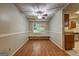 Charming dining room features hardwood floors, a ceiling fan, and a window bench at 3681 Chestnut Lake Ct, Jonesboro, GA 30236