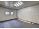 Spacious garage with overhead lighting, a clean carpeted floor, and multiple storage areas at 3681 Chestnut Lake Ct, Jonesboro, GA 30236