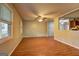 Bright living room boasts hardwood floors, a ceiling fan, and natural light from large windows at 3681 Chestnut Lake Ct, Jonesboro, GA 30236