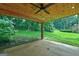 Outdoor patio with wood ceiling and lush backyard views at 3681 Chestnut Lake Ct, Jonesboro, GA 30236