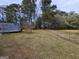 Large backyard with a wooden deck, a chainlink fence, and plenty of room for activities at 164 Turner Creek Dr, Hampton, GA 30228