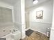 Bathroom features a shower, bathtub, and white trim with a window for natural light at 164 Turner Creek Dr, Hampton, GA 30228