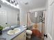Bathroom with tub shower combo with decorative curtain, blue vanity and neutral walls at 164 Turner Creek Dr, Hampton, GA 30228