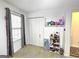 Bedroom with large window, closet, shelving with toys, and gray carpet at 164 Turner Creek Dr, Hampton, GA 30228