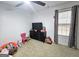 Bedroom with a large window, dresser, and a cozy area for playing with a pink chair at 164 Turner Creek Dr, Hampton, GA 30228