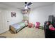 Bedroom with large window, bed, small shelving units, dresser and pink chair at 164 Turner Creek Dr, Hampton, GA 30228