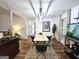 Well-lit dining room featuring modern decor, wood-look floors, and a contemporary light fixture at 164 Turner Creek Dr, Hampton, GA 30228