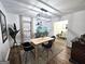 Dining room featuring wood floors, modern light fixture, and a decorative aquarium at 164 Turner Creek Dr, Hampton, GA 30228