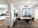 Dining room featuring wood floors, modern light fixture, and access to the kitchen at 164 Turner Creek Dr, Hampton, GA 30228