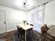 Bright dining room featuring a modern light fixture, a wood table, and a black and white rug at 164 Turner Creek Dr, Hampton, GA 30228