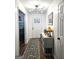 Bright entryway with wood floors, a stylish light fixture, and a decorative accent table at 164 Turner Creek Dr, Hampton, GA 30228