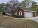Lovely red brick home with white trim, an attached garage, and a well-manicured lawn at 164 Turner Creek Dr, Hampton, GA 30228