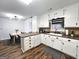 Bright kitchen with white cabinetry, sleek appliances, and a view into the dining area at 164 Turner Creek Dr, Hampton, GA 30228