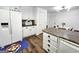Bright kitchen with white cabinets and modern appliances near the dining area at 164 Turner Creek Dr, Hampton, GA 30228