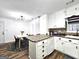 Bright kitchen with white cabinetry, sleek appliances, and a view into the dining area at 164 Turner Creek Dr, Hampton, GA 30228