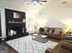 Cozy living room with a brick fireplace, ceiling fan, and comfortable seating arrangement at 164 Turner Creek Dr, Hampton, GA 30228