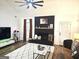 Stylish living space featuring a modern fireplace, decorative rug, and comfortable seating area at 164 Turner Creek Dr, Hampton, GA 30228