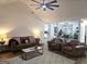 Bright living room with vaulted ceilings, ceiling fan, modern furnishings and wood laminate flooring at 164 Turner Creek Dr, Hampton, GA 30228