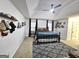 Spacious bedroom with a vaulted ceiling, ceiling fan, large bed, soft gray rug and picture shelves at 164 Turner Creek Dr, Hampton, GA 30228