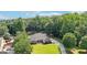 Drone shot capturing a home's curb appeal with a lush green yard and tree lined landscape at 320 Silverbell Ln, Sharpsburg, GA 30277