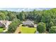 Aerial view of a beautiful house nestled amongst mature trees, showcasing its serene, private setting at 320 Silverbell Ln, Sharpsburg, GA 30277