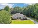Aerial view of a suburban home with lush greenery, mature trees and well manicured lawn at 320 Silverbell Ln, Sharpsburg, GA 30277