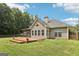 A well manicured backyard featuring a multi-tiered deck and lush green lawn at 320 Silverbell Ln, Sharpsburg, GA 30277