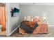 Well-lit bedroom with hardwood floors, television, closet, and en-suite bathroom with shower at 320 Silverbell Ln, Sharpsburg, GA 30277