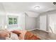 Open bedroom featuring hardwood floors, a window, and a door with access to a closet at 320 Silverbell Ln, Sharpsburg, GA 30277