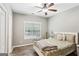Comfortable bedroom features a ceiling fan, wood-look flooring, and a window with natural light at 320 Silverbell Ln, Sharpsburg, GA 30277