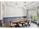 Elegant dining room with a long wooden table, stylish chairs, and modern pendant lighting at 320 Silverbell Ln, Sharpsburg, GA 30277