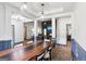 Dining room showcases a large table, modern pendant lights, and views into the living room at 320 Silverbell Ln, Sharpsburg, GA 30277
