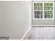 Neutral room featuring hardwood floors, natural light, and a large window view at 320 Silverbell Ln, Sharpsburg, GA 30277