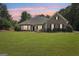 Charming single-Gathering home featuring stone accents, manicured landscaping, and a well-maintained lawn at 320 Silverbell Ln, Sharpsburg, GA 30277