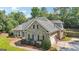 Exterior view of this beautiful home showcasing the stone facade, attached garage, and well-maintained yard at 320 Silverbell Ln, Sharpsburg, GA 30277