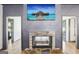Stone fireplace with a mounted TV and open doorways on both sides adds character to the home at 320 Silverbell Ln, Sharpsburg, GA 30277