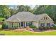 Attractive single-story home with stone accents, lush lawn and mature landscaping at 320 Silverbell Ln, Sharpsburg, GA 30277