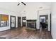 Spacious living room with hardwood floors, modern fireplace, and plenty of natural light at 320 Silverbell Ln, Sharpsburg, GA 30277
