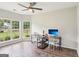 Sunlit office space with hardwood floors, dual desks, and large windows overlooking the front yard at 320 Silverbell Ln, Sharpsburg, GA 30277