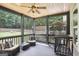 Relaxing screened porch with ceiling fan, outdoor seating and view of the fenced backyard at 320 Silverbell Ln, Sharpsburg, GA 30277