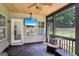 Cozy screened porch features a ceiling fan, outdoor seating, and a mounted television for entertainment at 320 Silverbell Ln, Sharpsburg, GA 30277