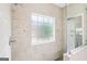 Modern tiled shower with glass enclosure and chrome fixtures and a window for natural light at 320 Silverbell Ln, Sharpsburg, GA 30277