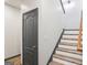 Staircase featuring hardwood steps, a gray door, and neutral paint at 320 Silverbell Ln, Sharpsburg, GA 30277