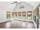 Bright sun room with vaulted ceiling, transom window, and many windows with woven shades at 320 Silverbell Ln, Sharpsburg, GA 30277