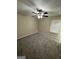 Comfortable bedroom with plush carpet, a ceiling fan, and a window for natural light at 9107 Morris Sw Dr, Covington, GA 30014