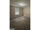 Cozy bedroom with plush carpet, a window for natural light, and neutral paint at 9107 Morris Sw Dr, Covington, GA 30014