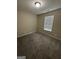 Cozy bedroom with plush carpet, a window for natural light, and neutral paint at 9107 Morris Sw Dr, Covington, GA 30014