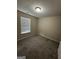 Comfortable bedroom with plush carpet, a window for natural light, and neutral paint at 9107 Morris Sw Dr, Covington, GA 30014
