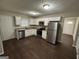 Modern kitchen features stainless steel appliances, white cabinets, and granite countertops at 9107 Morris Sw Dr, Covington, GA 30014