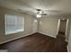Inviting living room with hardwood floors, neutral paint, a ceiling fan, and ample natural light at 9107 Morris Sw Dr, Covington, GA 30014